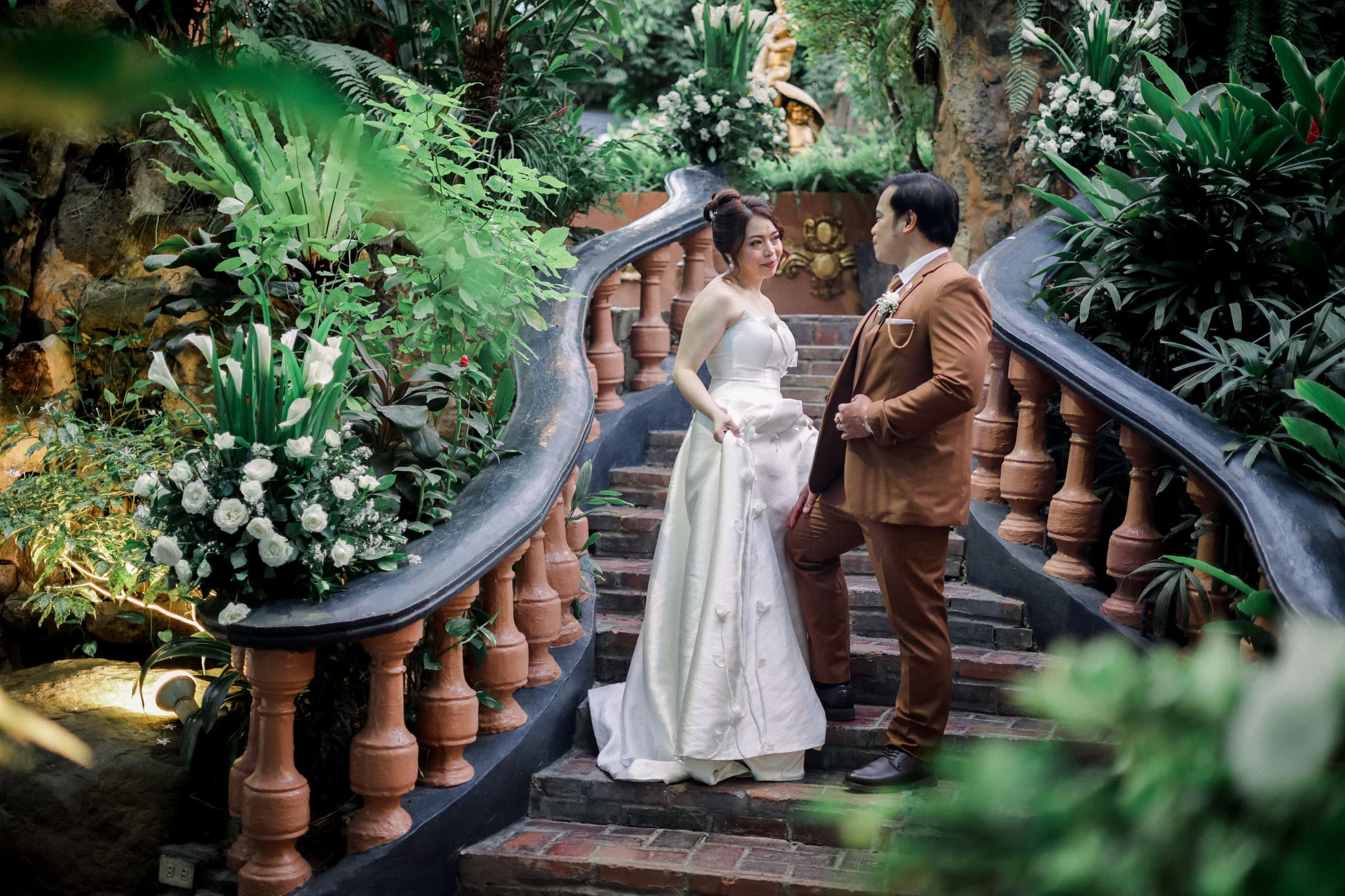 Wedding couple on a garden staircase